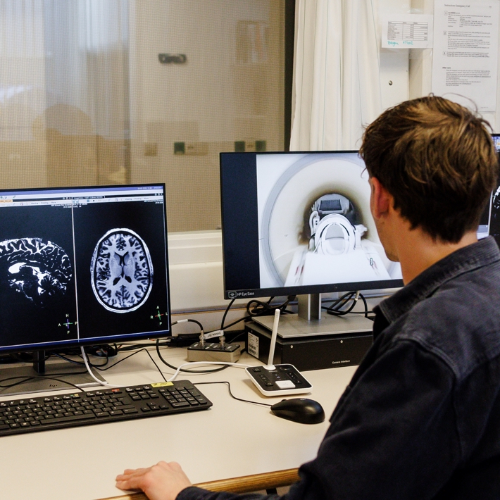 Researcher operating the 7 Tesla MRI scanner