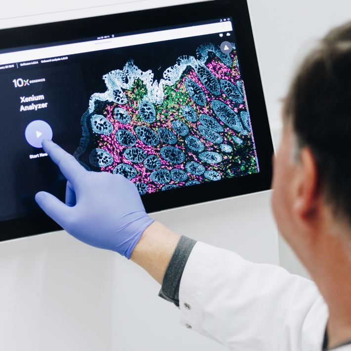 A technician starts an spatial transcriptomics run