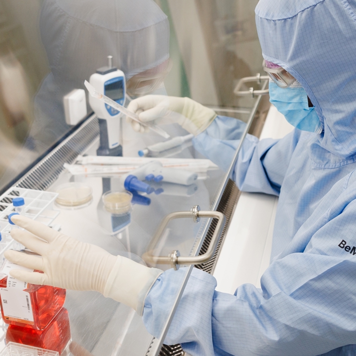 Close-up of person working in a biosafety cabinet in the cleanroom