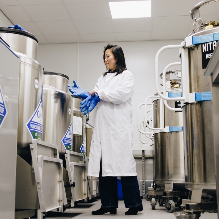 Person putting on gloves in the nitrogen storage area