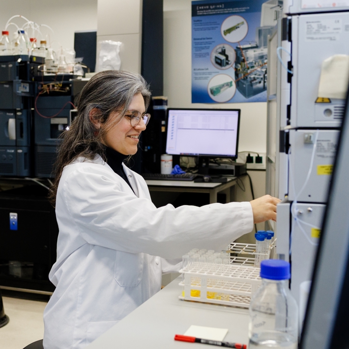 Researcher working with device in lab