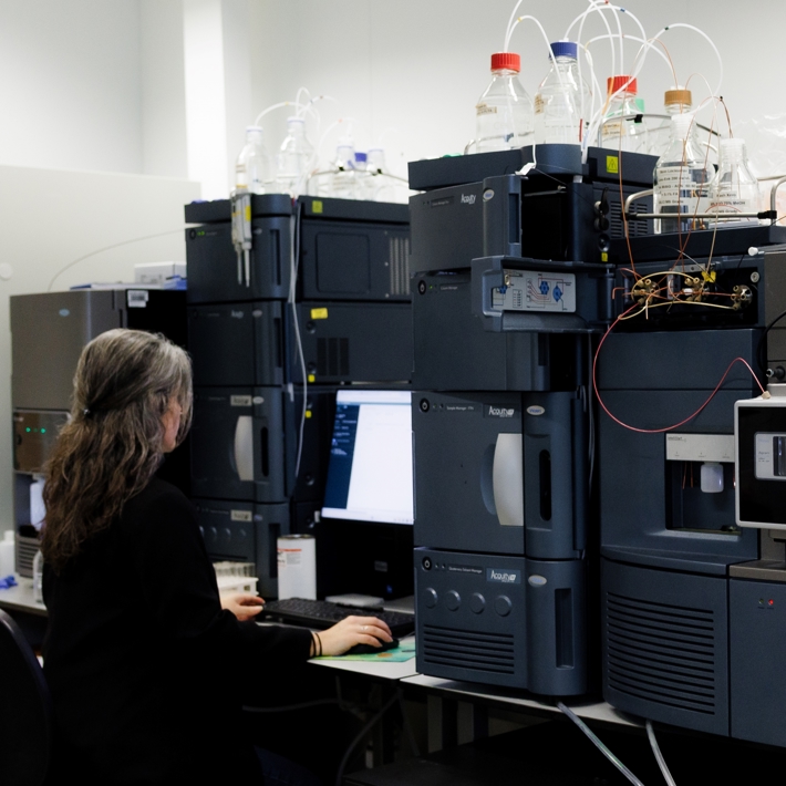 Researcher working with device in lab